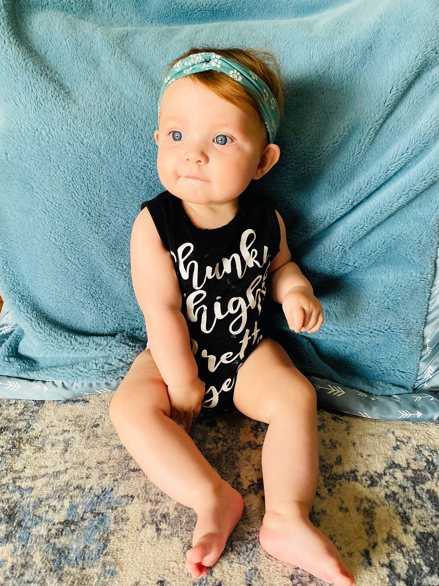 Vivianne joined the competition — help win amazing prizes! baby, baby_toddler_clothing, barefoot, child, fashion_accessory, flooring, foot, happy, headgear, human_leg, knee, neck, pattern, person, portrait_photography, sitting, skin, sleeve, t_shirt, thigh