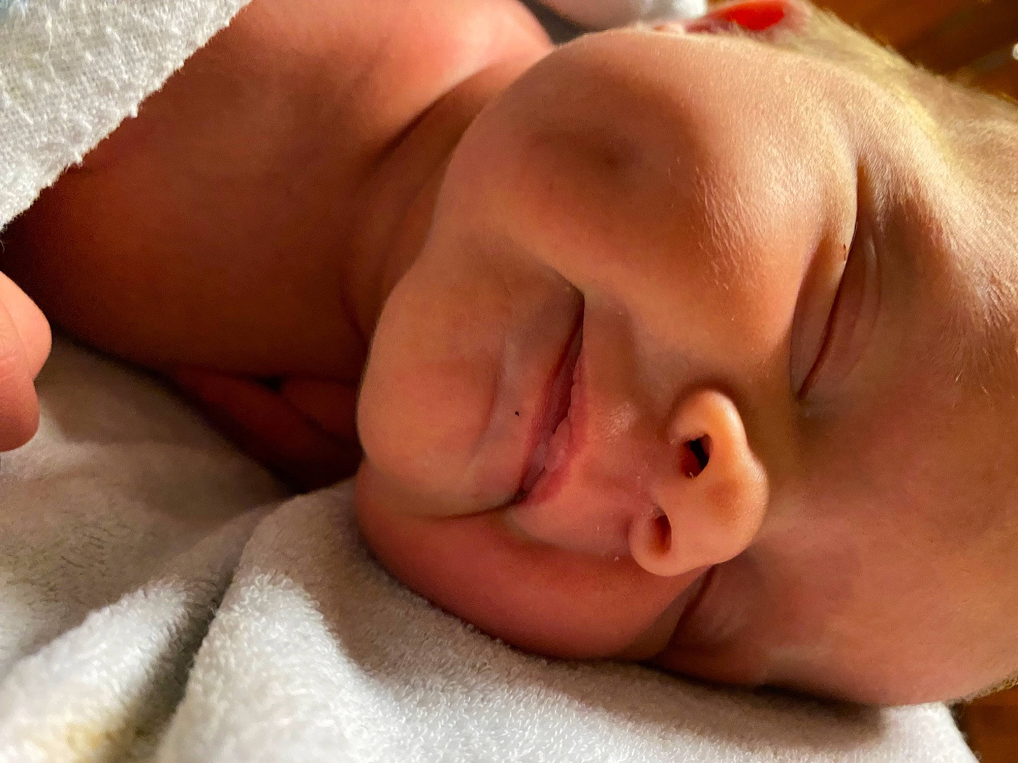 Chandler is registered to the contest to win money with this photo: baby, cheek, comfort, eye, eyebrow, eyelash, finger, gesture, hand, head, headgear, human_body, lip, mouth, muscle, neck, nose, person, skin, thumb