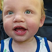 Jethro is registered to the contest to win money with this photo: toddler, child, smile, face, tank_top, patterned_clothing, green_eyes, happy, cute, baby, portrait, close_up, summer_clothing, outdoor, young_child, skin, hair, expression, sitting, clothing