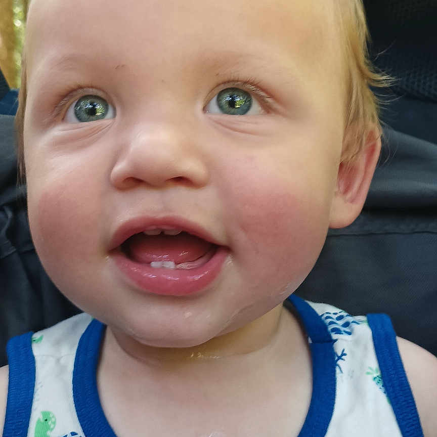 Jethro is registered to the contest to win money with this photo: baby, child, close_up, clothing, cute, expression, face, green_eyes, hair, happy, outdoor, patterned_clothing, portrait, sitting, skin, smile, summer_clothing, tank_top, toddler, young_child