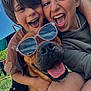 child, dog, sunglasses, smiling, happy, outdoor, sky, grass, clothing, face, tongue, nature, sunny, playful, fun, people, portrait, casual, summer, closeup