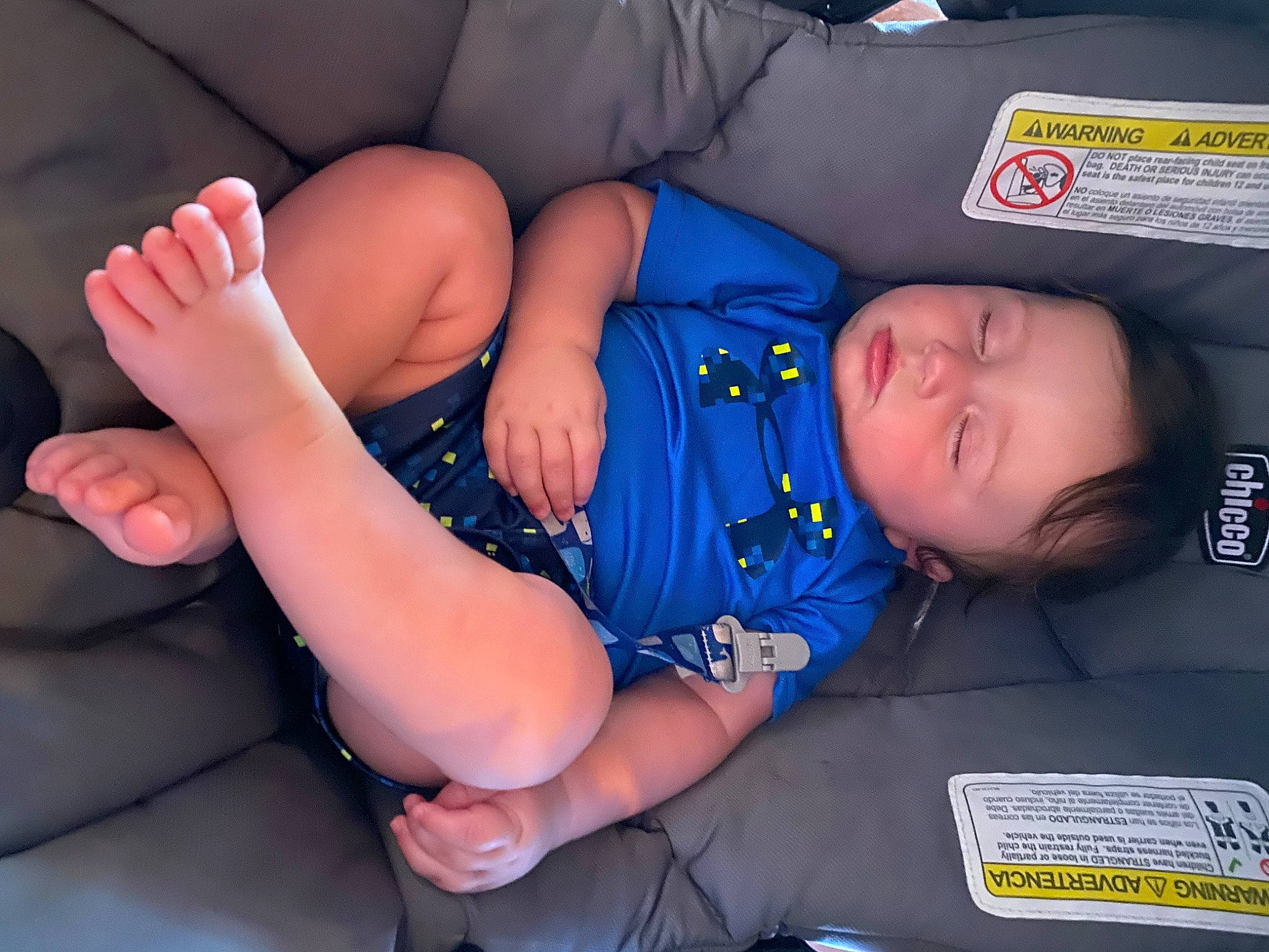 Walker is registered to the contest to win money with this photo: arm, baby, baby_sleeping, baby_toddler_clothing, child, comfort, elbow, face, finger, foot, gesture, hand, human_leg, knee, leg, mouth, person, thigh, thumb, toddler