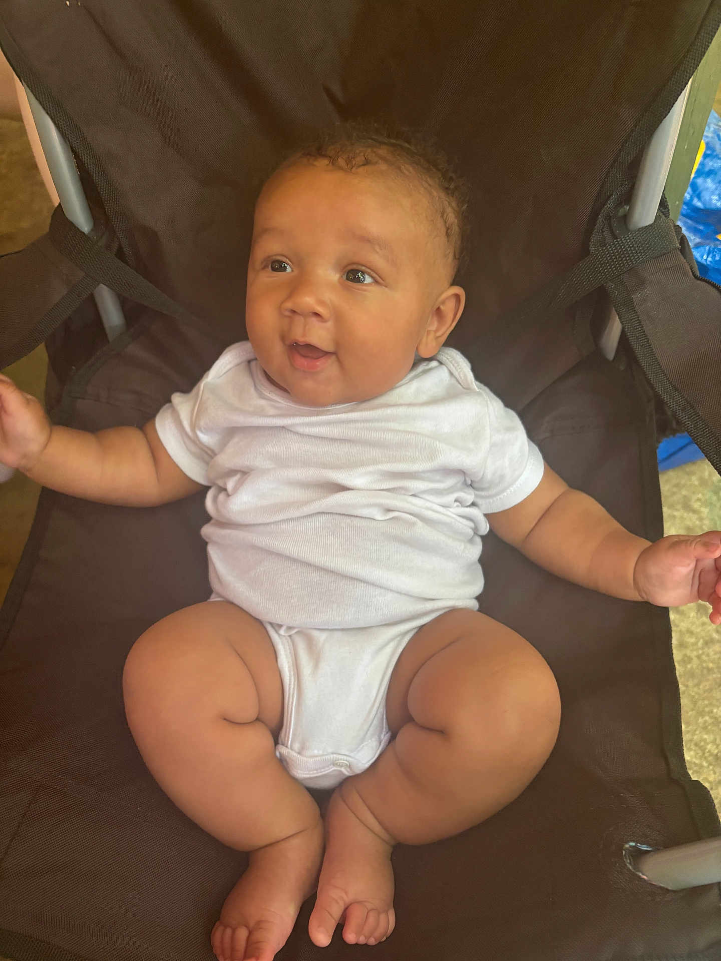 Jasai joined the competition — help win amazing prizes! baby, infant, onesie, chair, smiling, cute, happy, child, skin, arm, leg, foot, furniture, sitting, indoors, curly_hair, expression, comfort, relaxed, person
