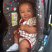 Jasai joined the competition — help win amazing prizes! baby, car_seat, smiling, infant, child, clothing, sneakers, footwear, person, seatbelt, polka_dots, striped, cute, happy, transportation, interior, car, safety, young_child, portrait