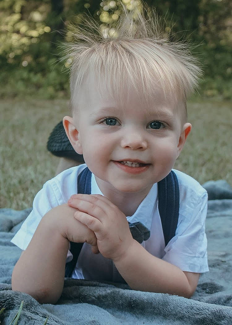 Brayson is registered to the contest to win money with this photo: blond, cheek, child, chin, eye, face, facial_expression, fun, grass, hair, hairstyle, head, iris, joy, lip, person, photograph, photography, skin, smile