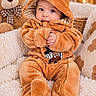 Derek is registered to the contest to win money with this photo: baby, child, infant, portrait, smiling, wide_eyed, hooded_outfit, onesie, plush_clothing, orange, teddy_bear, stuffed_animal, blanket, couch, cozy, indoor, nursery, sitting, soft_lighting, photography