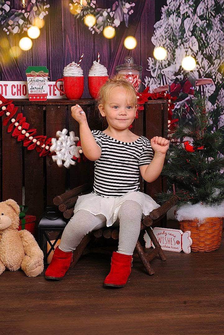 Tia is registered to the contest to win money with this photo: child, christmas, christmas_decoration, christmas_ornament, christmas_tree, conifer, event, fun, happy, holiday, joy, lap, ornament, party_supply, person, plant, sitting, stuffed_toy, toddler, toy