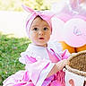 baby, child, pink_dress, headband, basket, balloons, outdoor, grass, portrait, curious, cute, celebration, first_birthday, ribbon, sunlight, holiday, smiling, one_year_old, infant, festive
