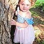 child, toddler, tree, dress, outdoor, nature, sunlight, grass, shoes, curious, face, smile, person, young, standing, playful, innocent, daylight, park, ground