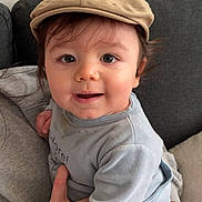 Livio participe au concours pour gagner de l'argent avec cette photo : baby, child, cap, clothing, couch, cute, face, hand, infant, indoors, light_blue, person, portrait, sitting, smile, soft_fabric, toddler, warmth, young_child, headwear