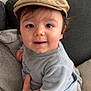 baby, child, cap, clothing, couch, cute, face, hand, infant, indoors, light_blue, person, portrait, sitting, smile, soft_fabric, toddler, warmth, young_child, headwear