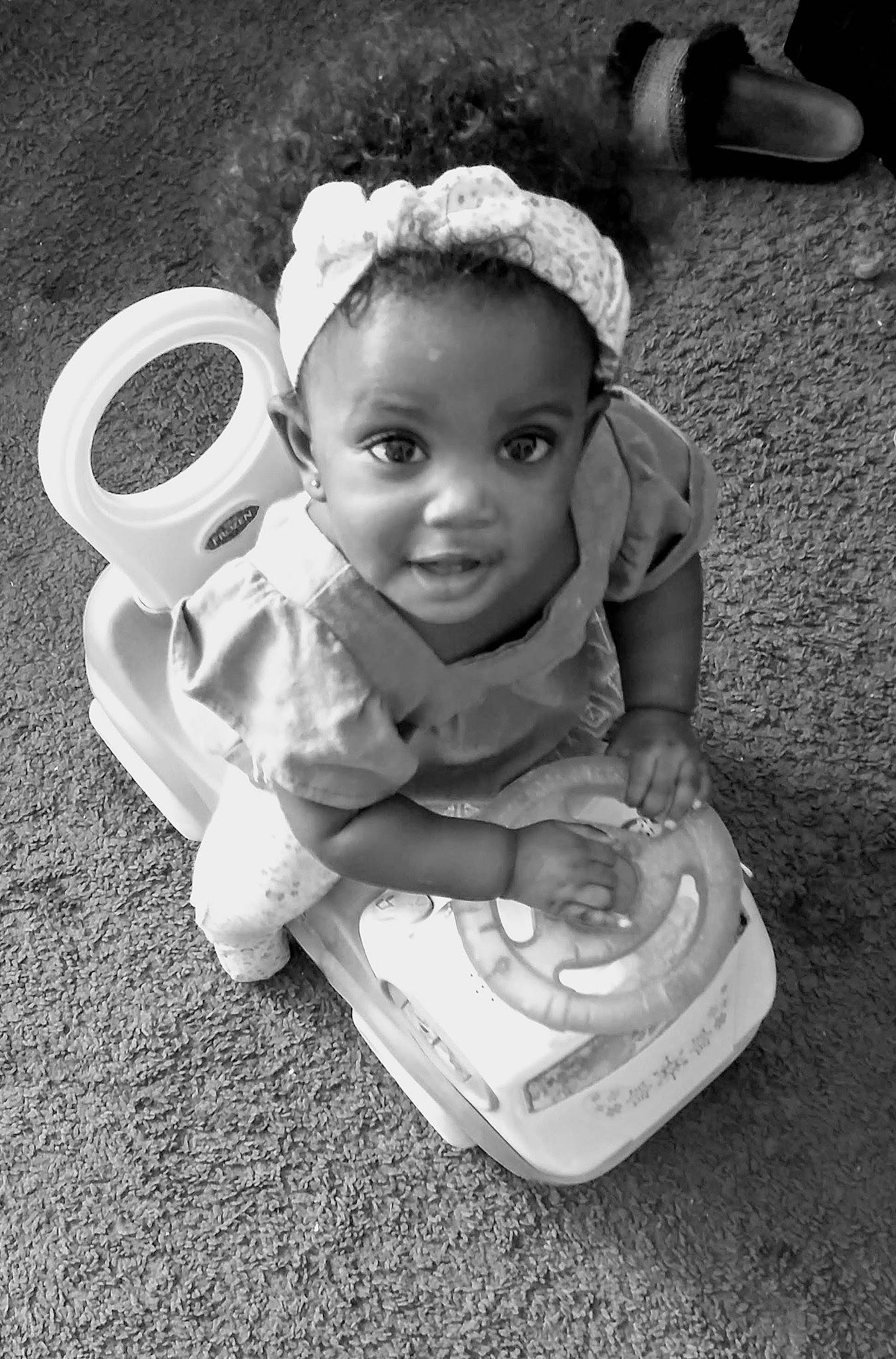 Alaysia is registered to the contest to win money with this photo: baby, black, black_and_white, child, coffee_cup, cup, drinkware, eye, head, monochrome, person, photograph, photography, sitting, smile, snapshot, stock_photography, tableware, toddler, white