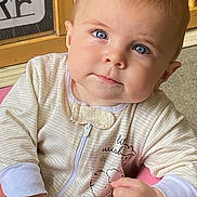 Wizdom joined the competition — help win amazing prizes! baby, blue_eyes, onesie, striped_clothing, pink_cushion, face, hand, curious, indoor, wooden_door, drawing, child, portrait, cute, infant, close_up, person, expression, soft_lighting, casual