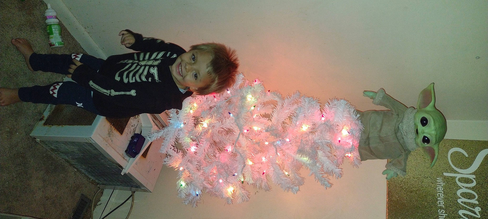 Jaxxon is registered to the contest to win money with this photo: christmas, christmas_ornament, event, fun, holiday, interior_design, joy, organism, ornament, party_supply, person, pink, plant, room, space, toddler, tree