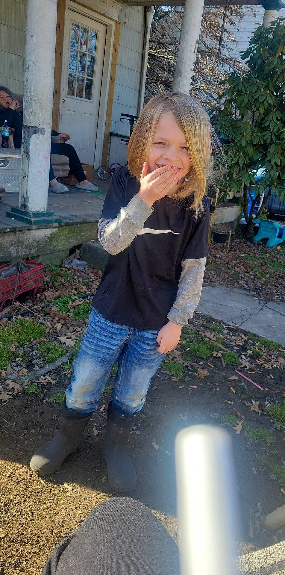 Gabriel is registered to the contest to win money with this photo: blond, denim, electric_blue, fun, garden, grass, happy, human_leg, joy, leisure, long_hair, person, plant, sitting, sleeve, smile, soil, t_shirt, thigh, toddler