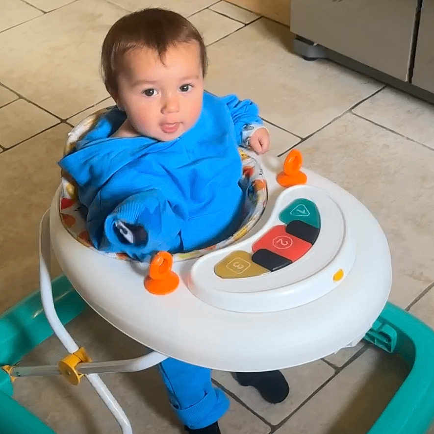 Mason is registered to the contest to win money with this photo: baby, basin, bathroom, chair, clothing, cutlery, face, furniture, head, highchair, hosiery, indoors, person, photography, portrait, room, sitting, sock, spoon, toilet