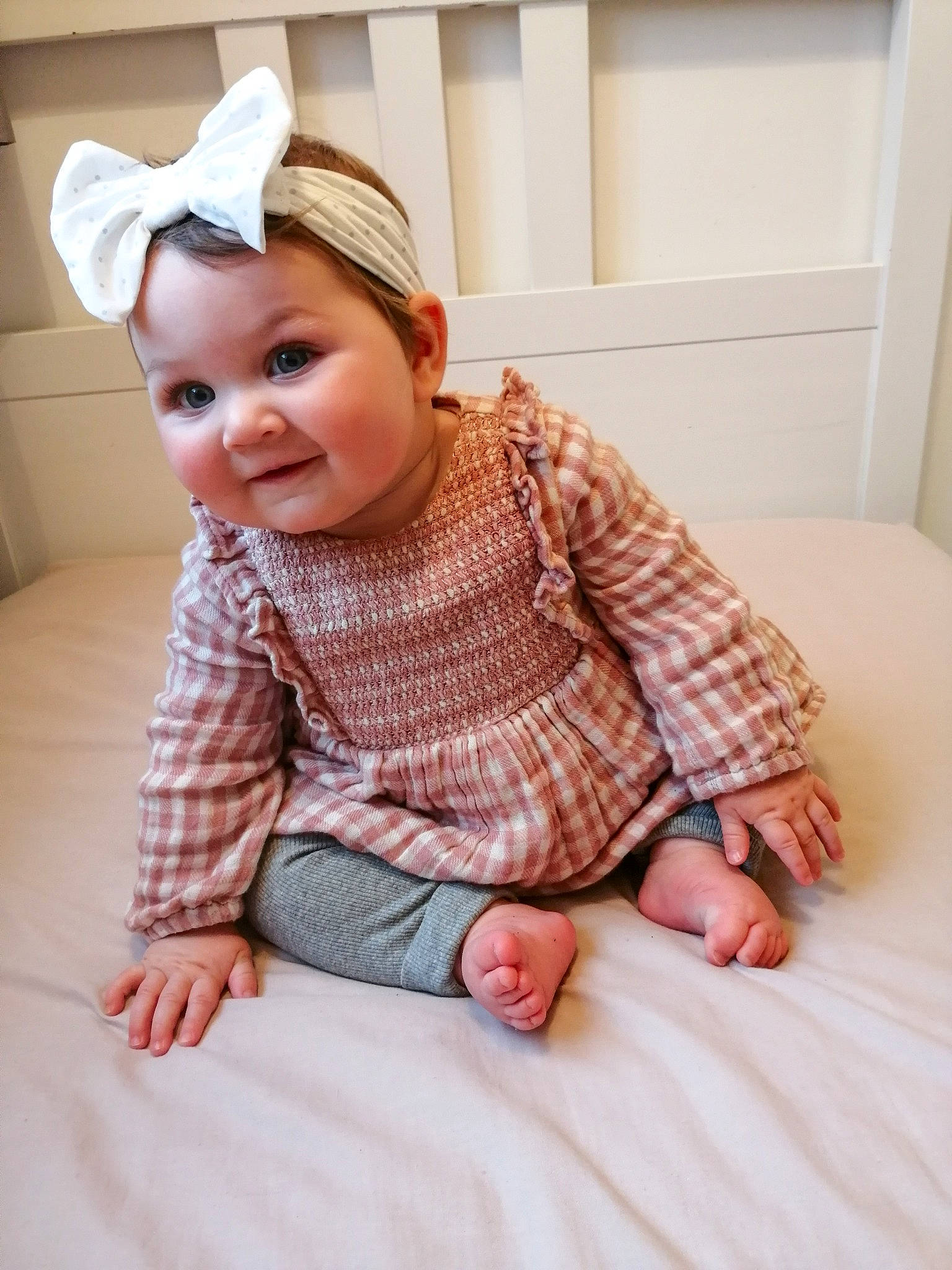 Darla joined the competition — help win amazing prizes! baby, baby_toddler_clothing, cap, comfort, dress, floor, flooring, happy, headwear, human_leg, leg, lip, outerwear, pattern, person, pink, skin, sleeve, smile, textile