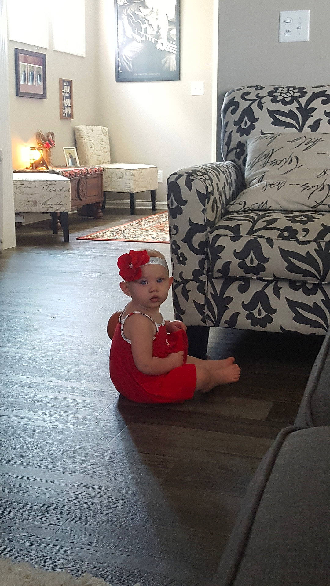 Maggie is registered to the contest to win money with this photo: chair, child, couch, day, design, floor, flooring, fun, furniture, girl, hardwood, home, house, interior_design, living_room, person, red, room, sitting, table