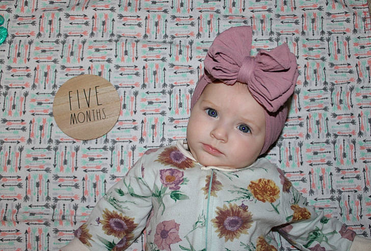 Harper is registered to the contest to win money with this photo: baby, beanie, cap, cheek, child, circle, costume_hat, eye, fashion_accessory, font, hair_accessory, happy, headgear, headwear, linens, pattern, peach, person, room, sleeve
