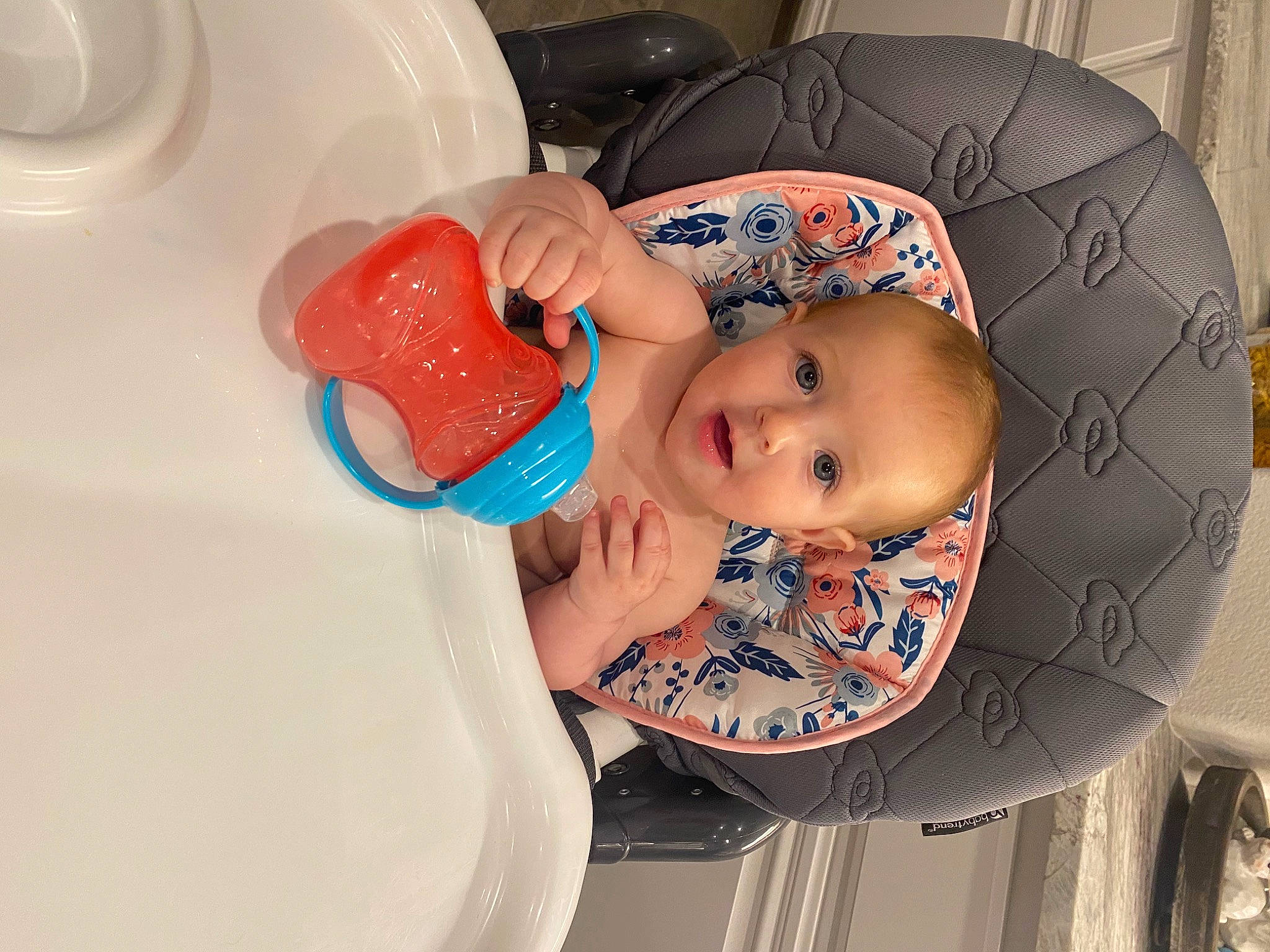 Harper is registered to the contest to win money with this photo: baby, baby_bathing, baby_products, baby_safety, baby_toddler_clothing, bathing, cheek, child, circle, drinkware, eyelash, headgear, person, plastic, plastic_bottle, room, toddler, water