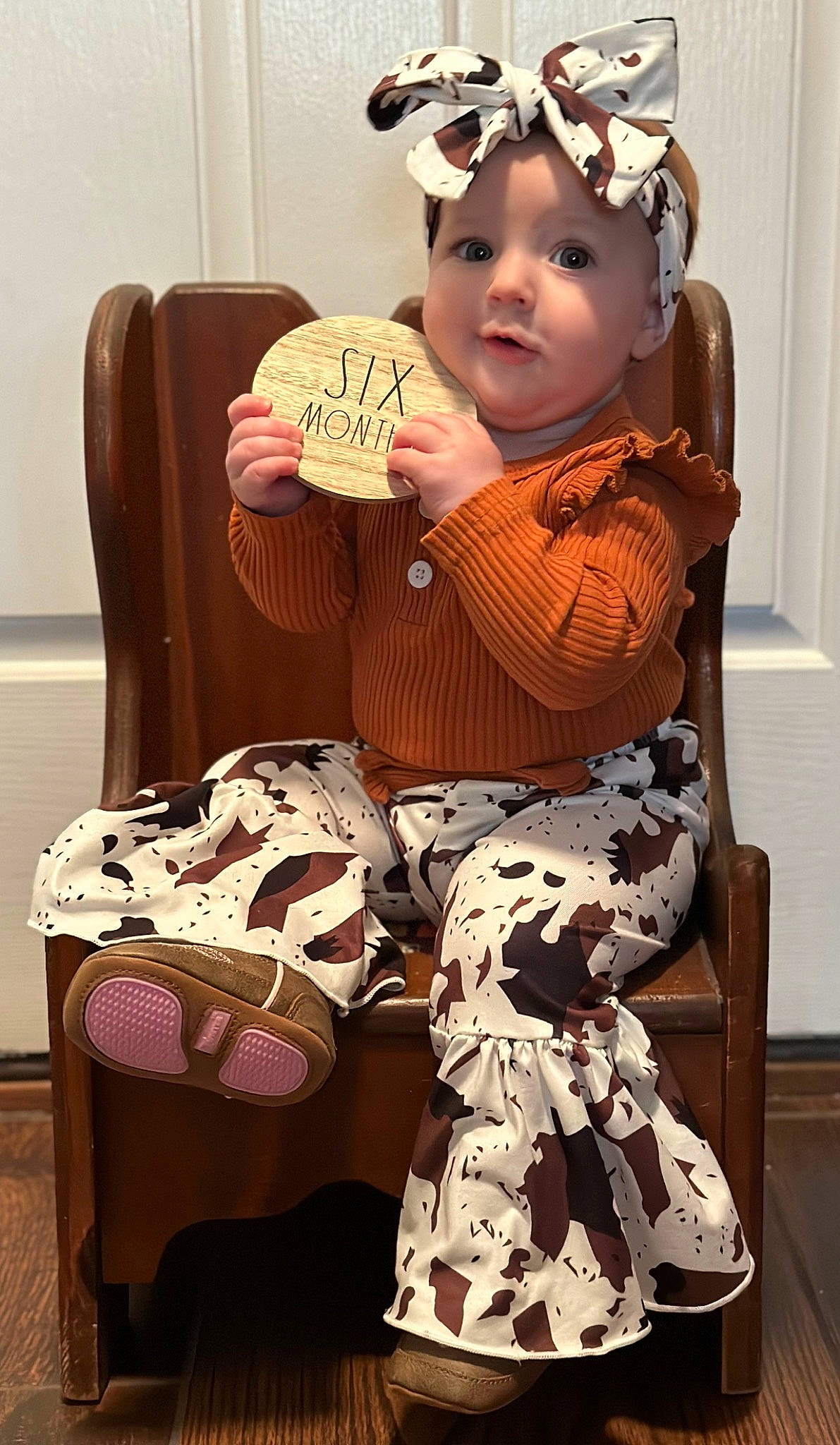 Harper is registered to the contest to win money with this photo: baby, baby_toddler_clothing, child, comfort, dress, eyewear, face, fashion_accessory, fashion_design, goggles, head, headwear, human_leg, knee, lap, pattern, person, personal_protective_equipment, sleeve, sunglasses