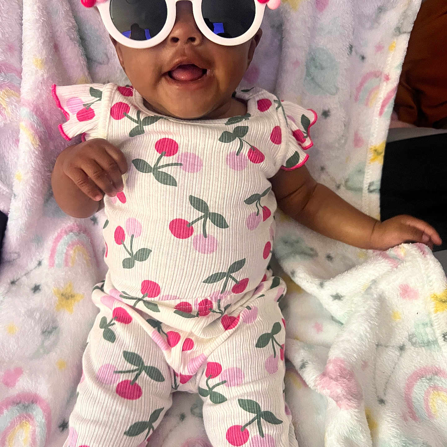 Amairgrace joined the competition — help win amazing prizes! baby, child, sunglasses, cherry_pattern, onesie, blanket, rainbow, star, smile, cute, infant, playful, soft_texture, colorful, person, clothing, indoor, portrait, happy, accessory