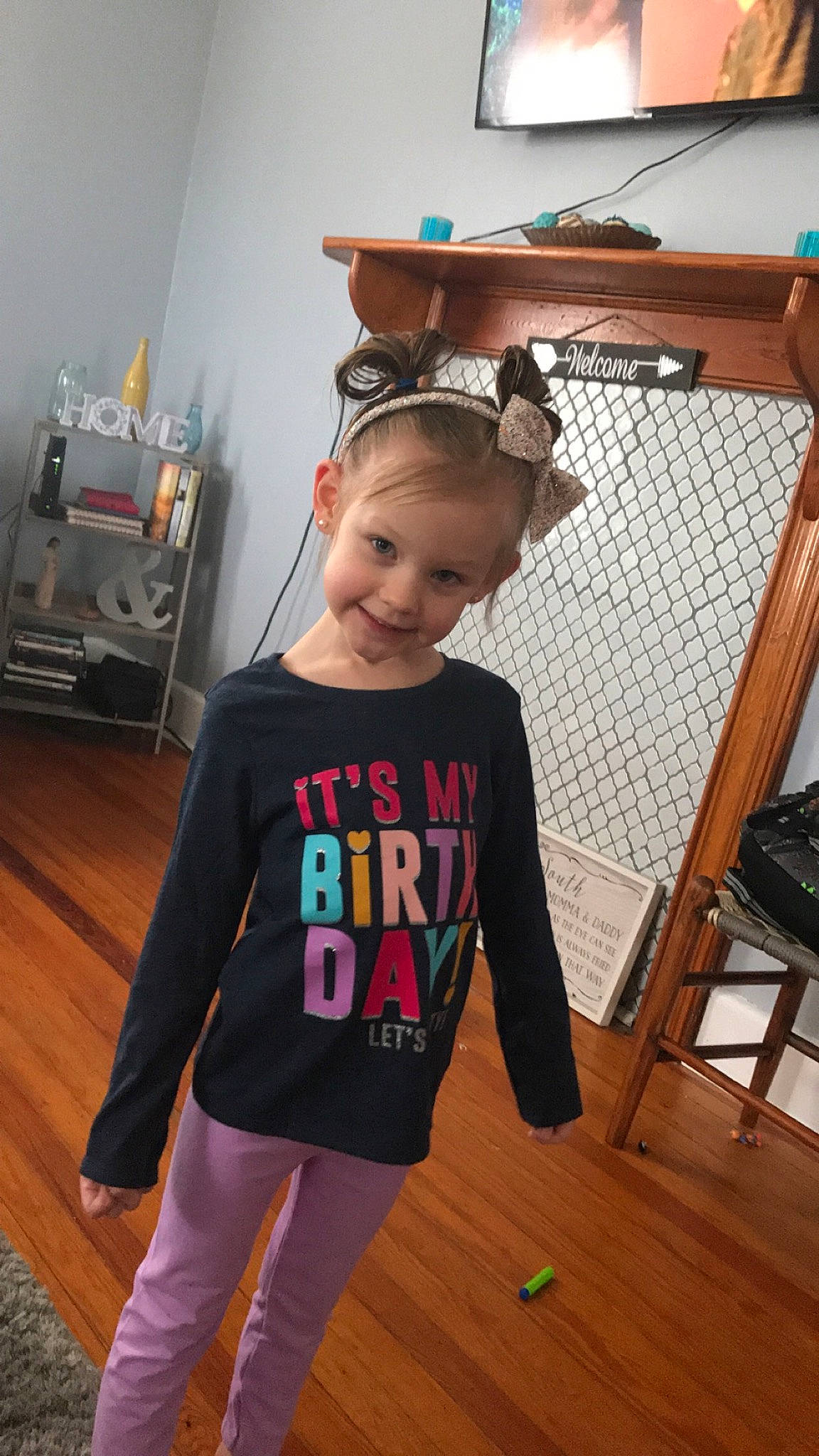 Lacy is registered to the contest to win money with this photo: child, clothing, flooring, joint, joy, neck, outerwear, person, play, room, shoulder, sleeve, sportswear, standing, t_shirt, toddler, top