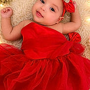 Shamilka joined the competition — help win amazing prizes! baby, red_dress, headband, flower, roses, fairy_lights, fluffy_rug, smiling, portrait, cute, infant, celebration, decor, tulle, sparkle, skin, person, lying_down, happy, closeup