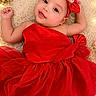 baby, red_dress, headband, flower, roses, fairy_lights, fluffy_rug, smiling, portrait, cute, infant, celebration, decor, tulle, sparkle, skin, person, lying_down, happy, closeup