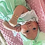 baby, infant, child, mint_green, bow, bracelet, blanket, pink, soft_texture, clothing, headwear, face, portrait, lying_down, cute, skin, hand, eyes, expression, indoor