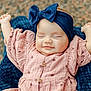 baby, infant, smiling, headband, bow, pink_dress, polka_dot, arms_up, blanket, cozy, outdoor, portrait, peaceful, happy, child, cute, closeup, face, sleepy, soft