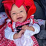 baby, child, smiling, red_bow, gingham_dress, white_cloth, stroller, soft_toy, bunny, happy, cute, infant, portrait, outdoor, clothing, headwear, baby_girl, playful, fabric, hands