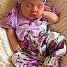 Lyla is registered to the contest to win money with this photo: baby, sleeping, infant, floral_outfit, headband, purple, blanket, soft_texture, peaceful, cute, newborn, portrait, child, resting, clothing, indoors, small_feet, hand, face, comfortable