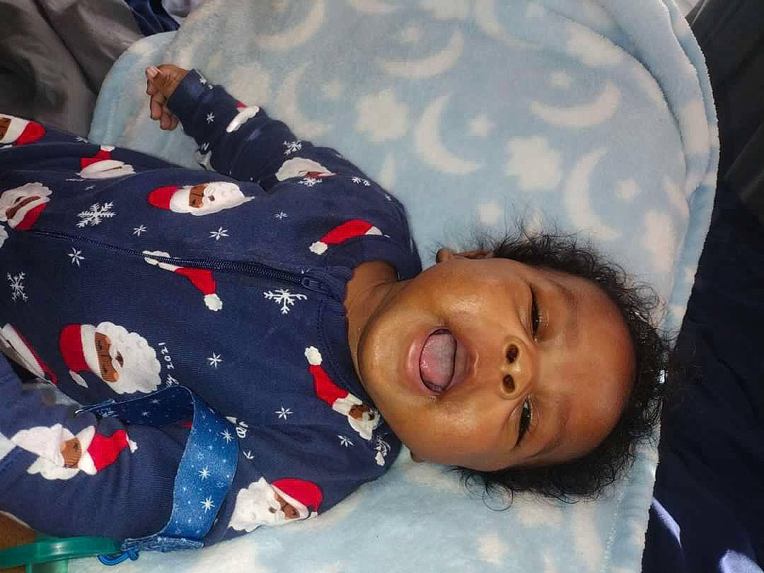 Junior is registered to the contest to win money with this photo: baby, baby_toddler_clothing, cheek, child, comfort, fun, happy, nap, pattern, person, portrait_photography, sitting, sleep, sleeve, smile, toddler, tree