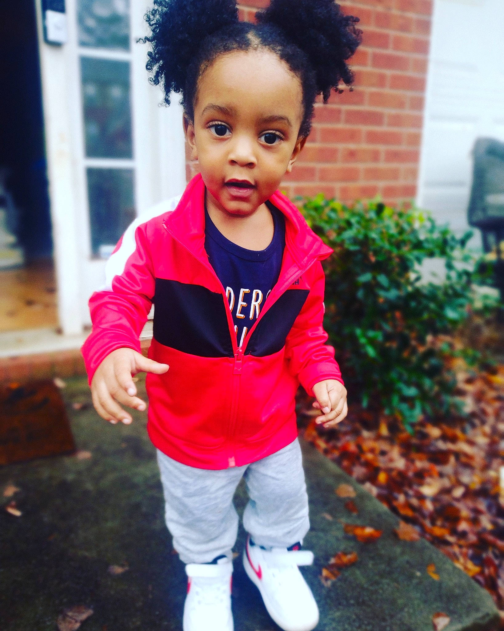 Zion is registered to the contest to win money with this photo: afro, baby_toddler_clothing, beauty, black, child, cool, electric_blue, eye, face, fun, grass, happy, head, magenta, person, pink, plant, red, sleeve, t_shirt