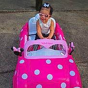 Nexielys joined the competition — help win amazing prizes! child, toddler, toy_car, pink, sunglasses, outdoor, concrete, picnic_table, play, minnie_mouse, polka_dots, bow, summer, sunny, cute, fun, vehicle, person, seat, toy