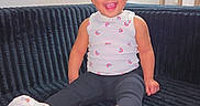 Nexielys joined the competition — help win amazing prizes! black_pants, child, couch, feet, furniture, hair_bun, happy, home, indoor, person, portrait, rainbow_pattern, room, shelf, sitting, smiling, toddler, toy, white_shoes, white_top