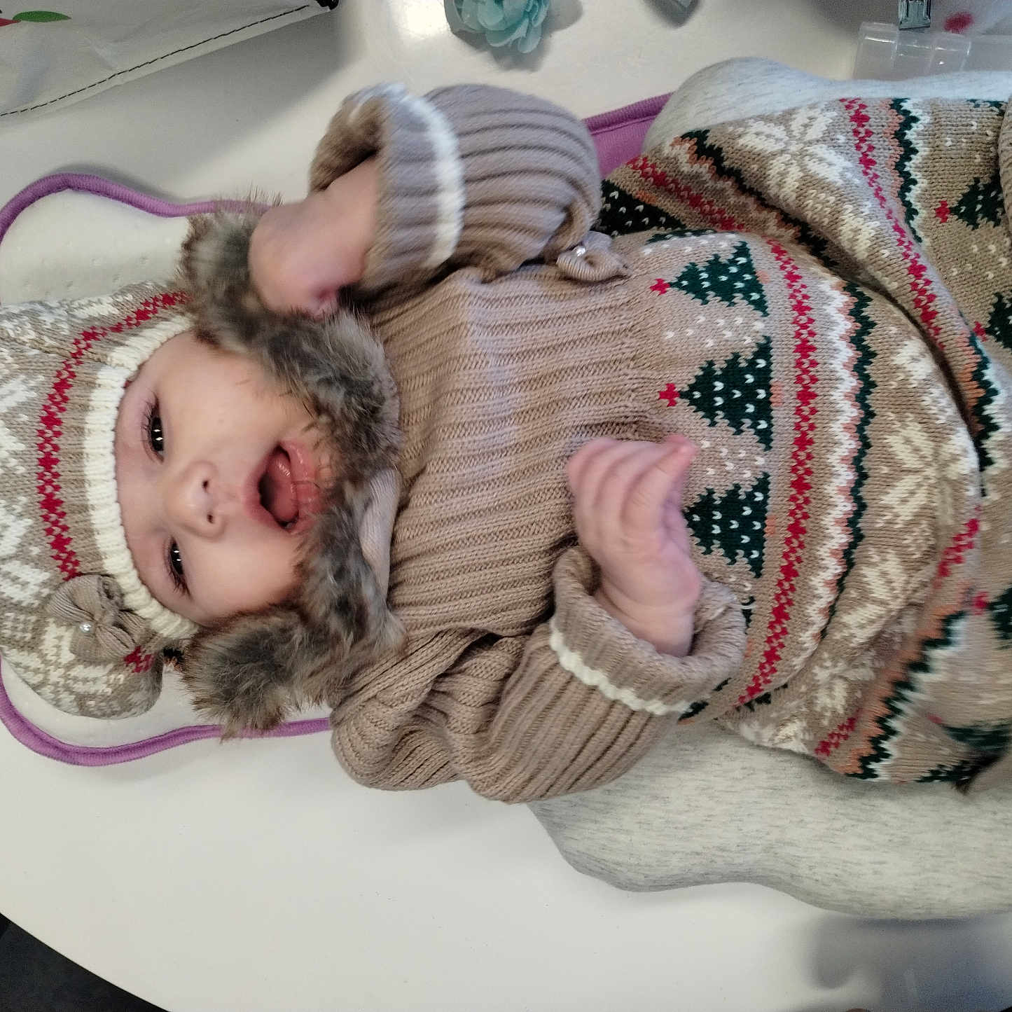 Alessia joined the competition — help win amazing prizes! baby, beanie, bodypart, bonnet, cap, clothing, couch, face, finger, glove, hand, hat, head, hood, hoodie, knitwear, newborn, person, sweater, sweatshirt