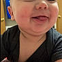 Navy is registered to the contest to win money with this photo: baby, smiling, tongue_out, close_up, blanket, indoor, child, cute, face, person, infant, happy, soft_texture, clothing, head, skin, expression, young, portrait, warm