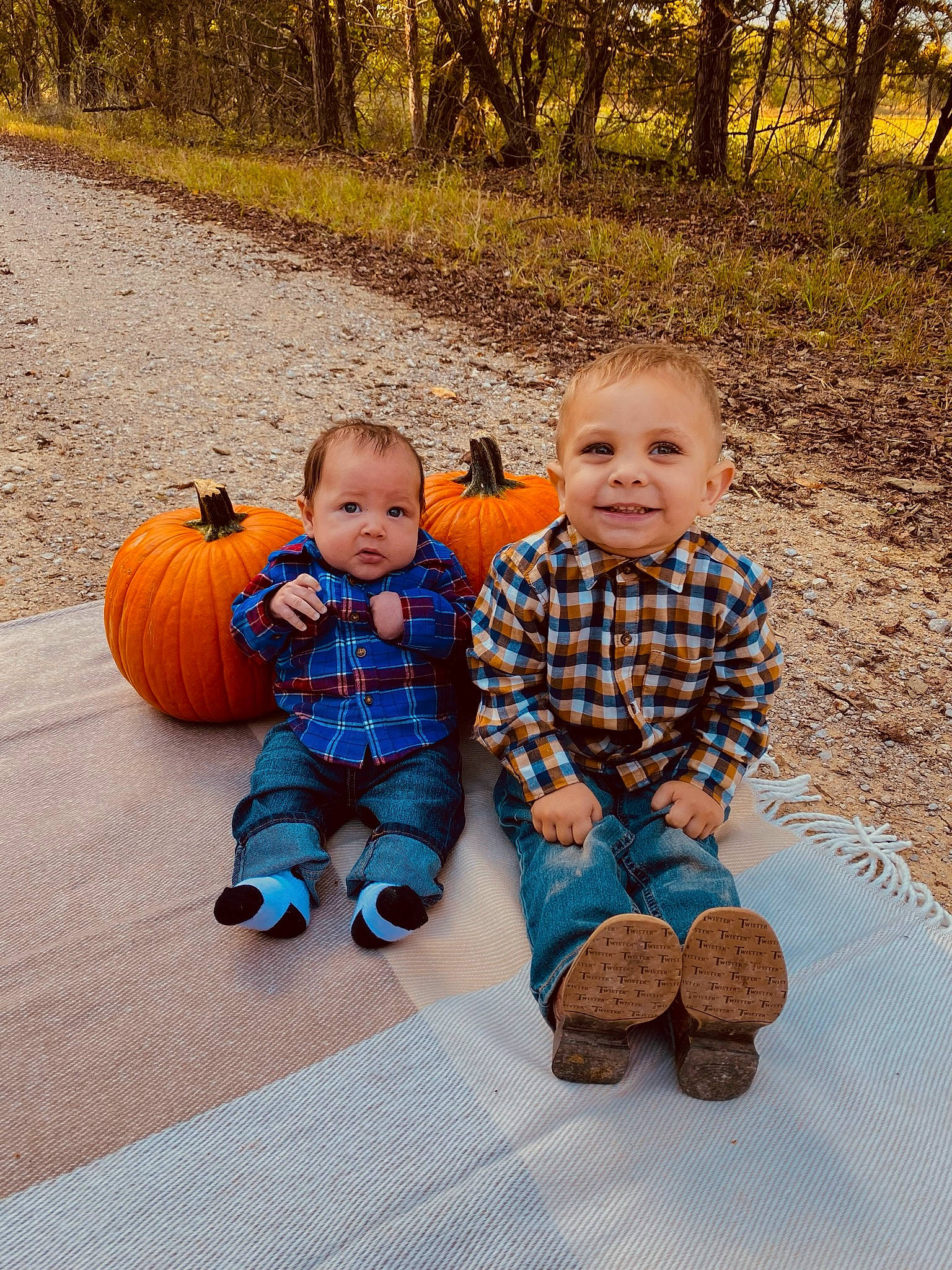 Everest joined the competition — help win amazing prizes! baby_toddler_clothing, eye, face, facial_expression, grass, happy, head, human_body, joy, leg, mammal, nature, orange, people_in_nature, person, plant, pumpkin, smile, toddler, tree