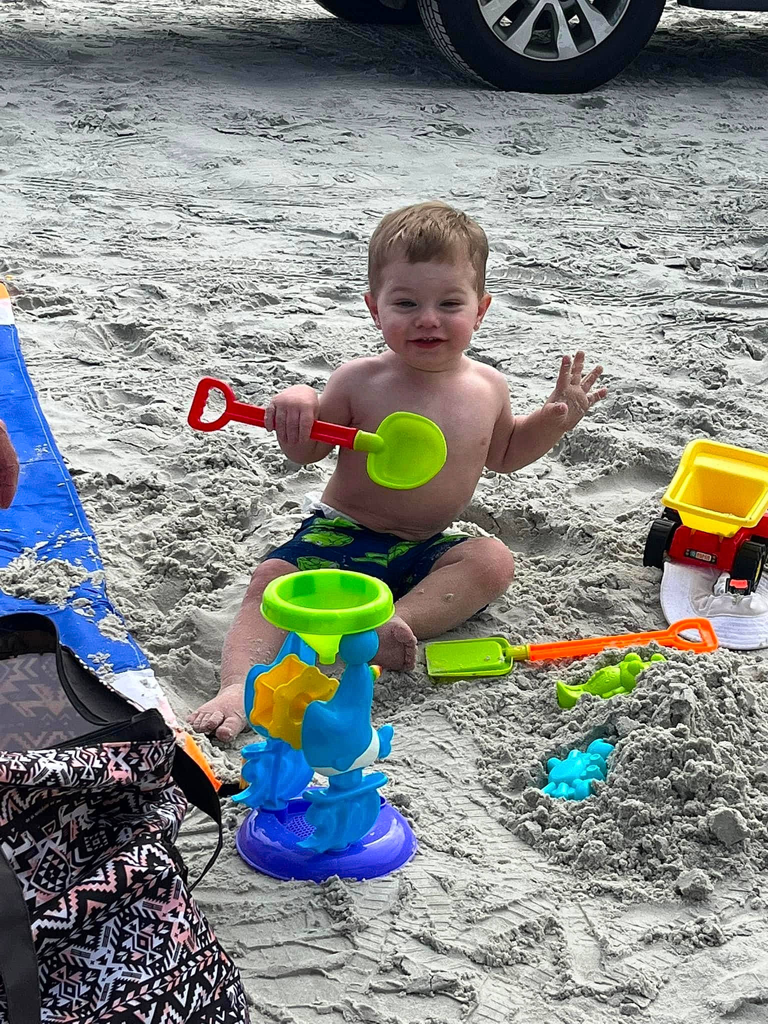 Kamren is registered to the contest to win money with this photo: automotive_tire, baby, child, event, fun, happy, joy, leisure, people, person, plastic, play, recreation, sand, smile, summer, tire, toddler, toy, vehicle_door