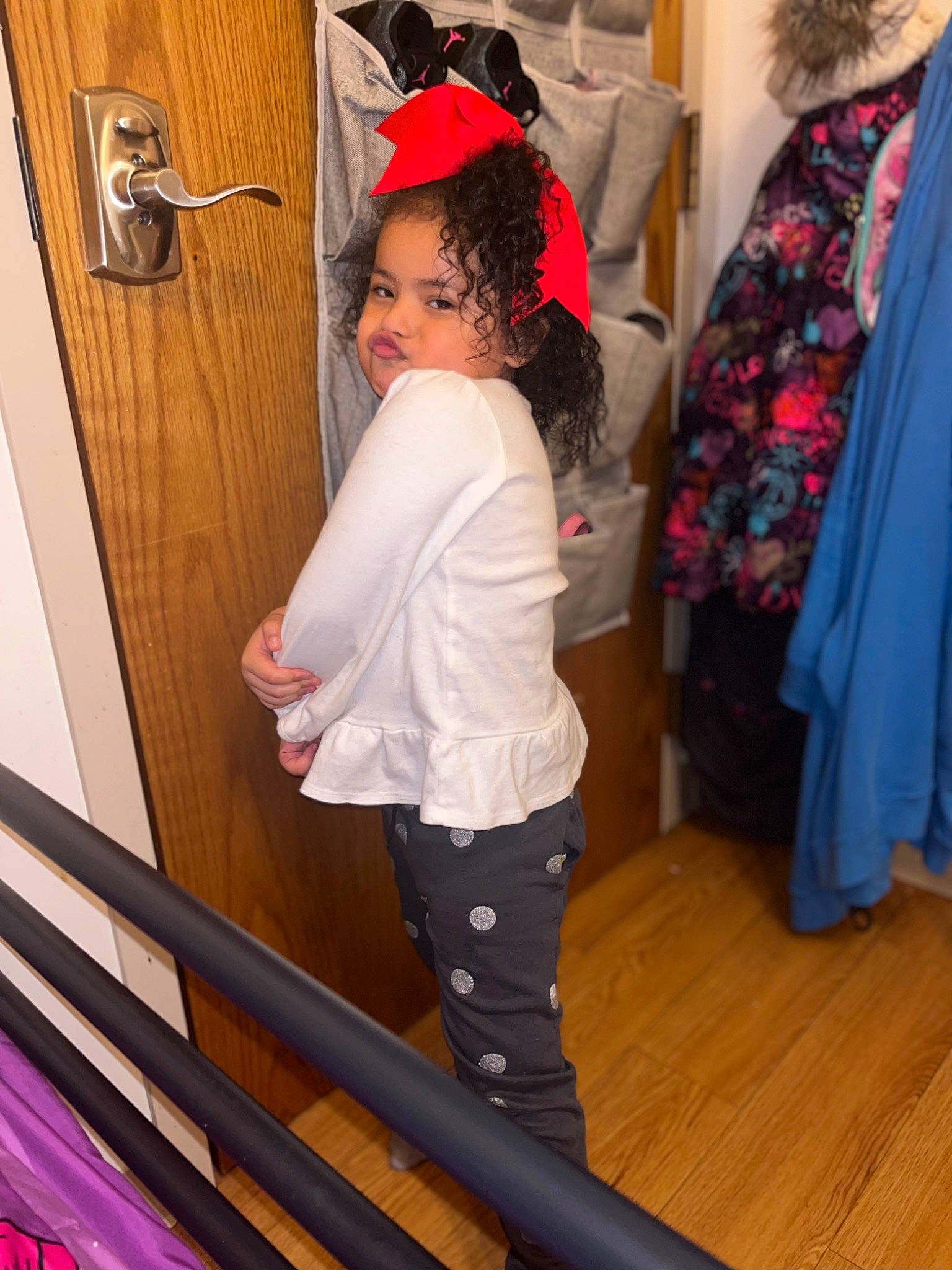 Kalia is registered to the contest to win money with this photo: cap, door, event, fashion_design, hardwood, joint, knee, magenta, outerwear, pattern, person, pink, shoulder, sleeve, stairs, standing, t_shirt, thigh, toddler, waist
