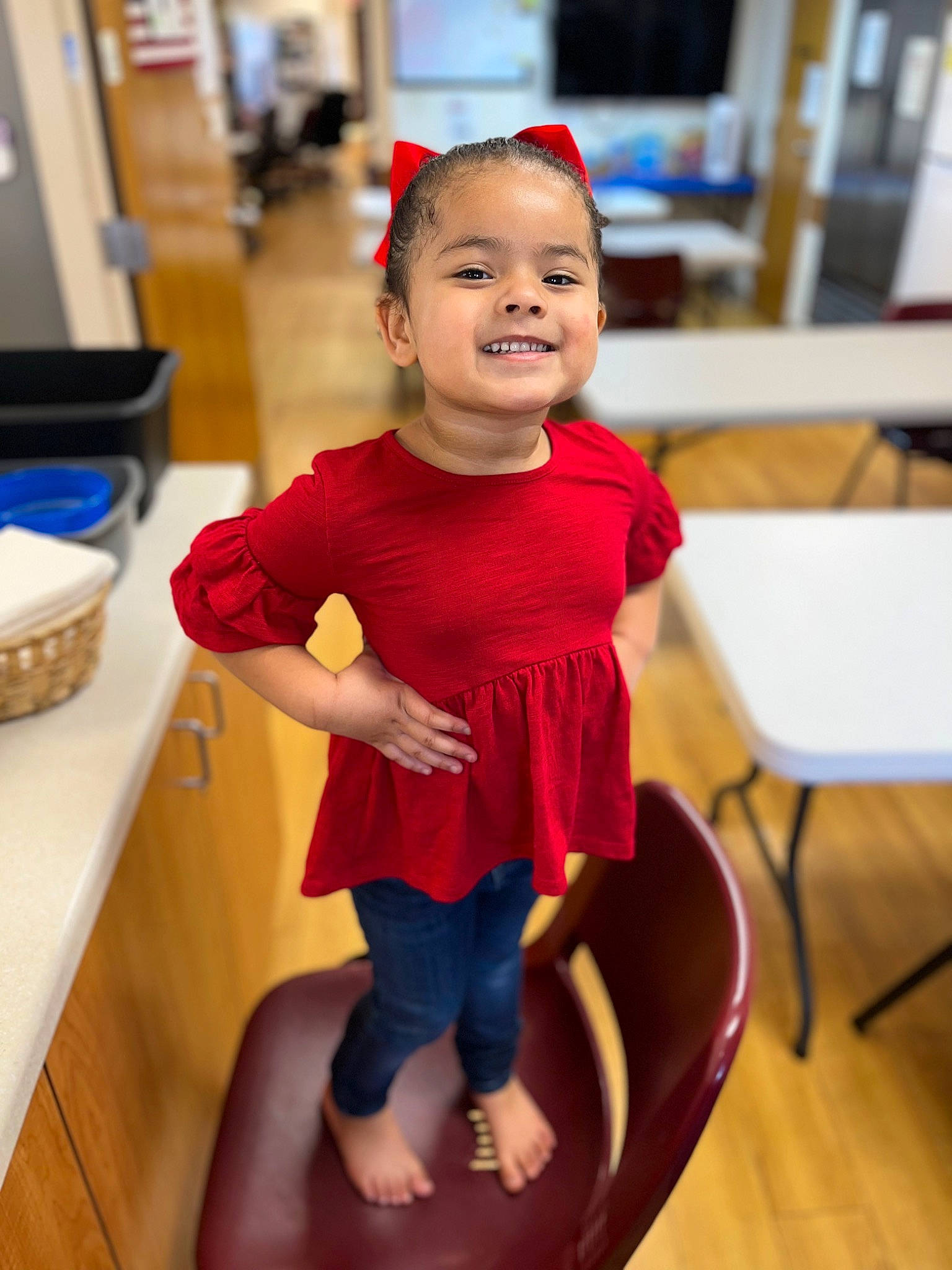 Kalia is registered to the contest to win money with this photo: baby_toddler_clothing, chair, child, event, fashion_design, floor, flooring, fun, happy, hardwood, human_leg, joy, leisure, magenta, person, room, sitting, sleeve, smile, thigh