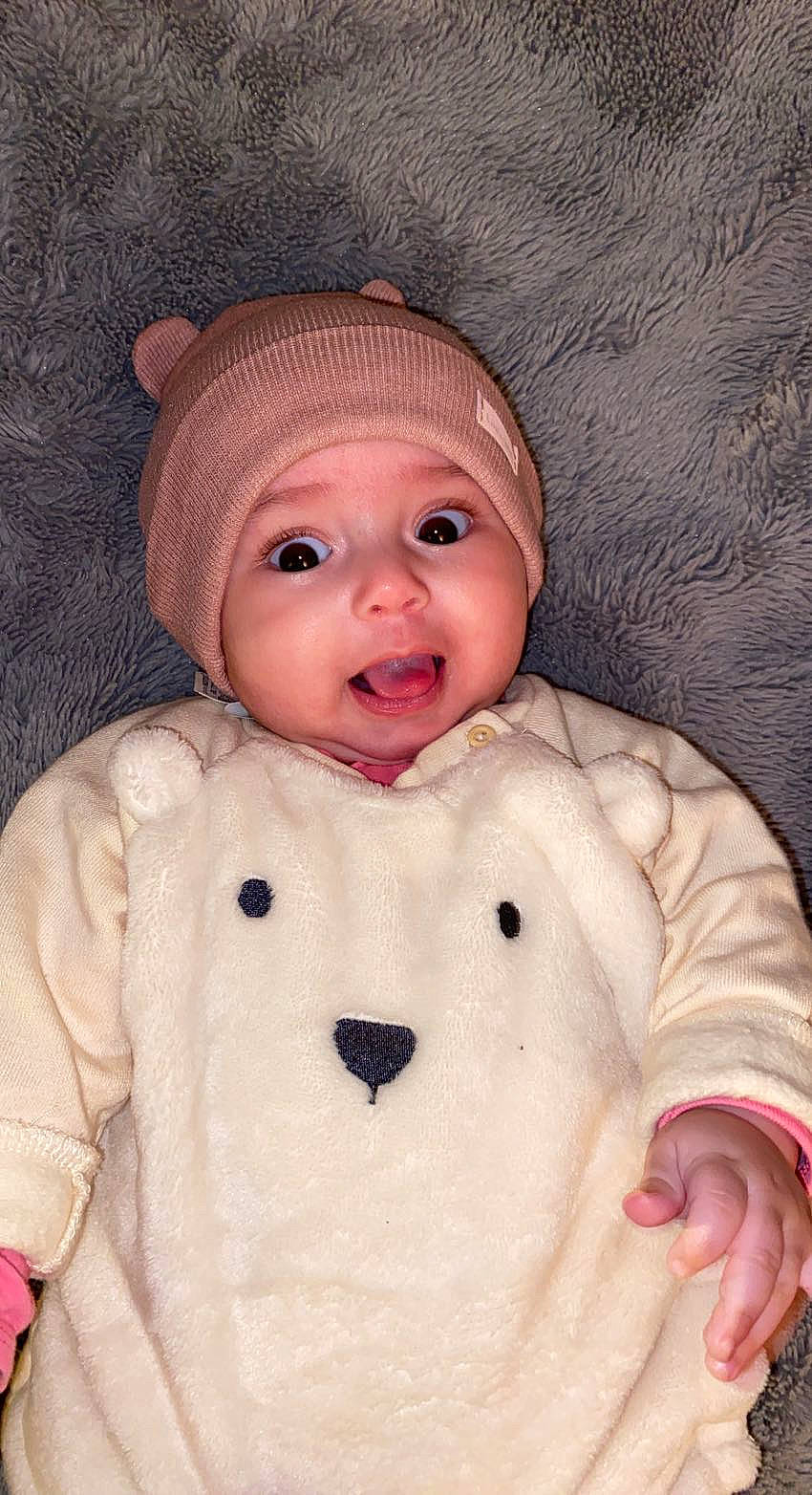 Safia participe au concours pour gagner de l'argent avec cette photo : baby, baby_toddler_clothing, cap, cheek, child, chin, eye, face, fur, happy, headwear, human_body, lip, nose, outerwear, person, pink, skin, sleeve, smile