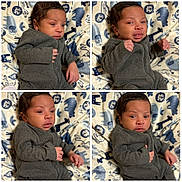Cameron is registered to the contest to win money with this photo: baby, infant, child, grey_clothing, blanket, animal_print, giraffe, elephant, lion, portrait, cute, expression, hands, lying_down, soft_texture, indoors, newborn, face, young_child, cozy