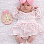 baby, infant, pink_bow, dress, socks, milestone, 1_month, blanket, cute, portrait, lying_down, soft, newborn, child, adorable, peaceful, celebration, headwear, feet, hands
