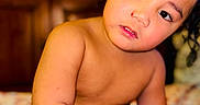 Presley joined the competition — help win amazing prizes! arm, baby, bed, blanket, child, curly_hair, cute, diaper, expression, eyes, face, furniture, head_tilt, indoors, person, portrait, room, skin, toddler, wood