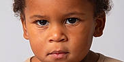Ange participe au concours pour gagner de l'argent avec cette photo : child, toddler, portrait, curly_hair, serious, face, eyes, skin, clothing, beige, sweater, expression, headshot, young, person, cute, studio, indoors, closeup, baby