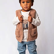 Ange participe au concours pour gagner de l'argent avec cette photo : toddler, child, standing, vest, fleece, shirt, bear_print, jeans, sneakers, vans, footwear, casual_clothing, portrait, studio, white_background, cute, fashion, young_child, person, looking_away