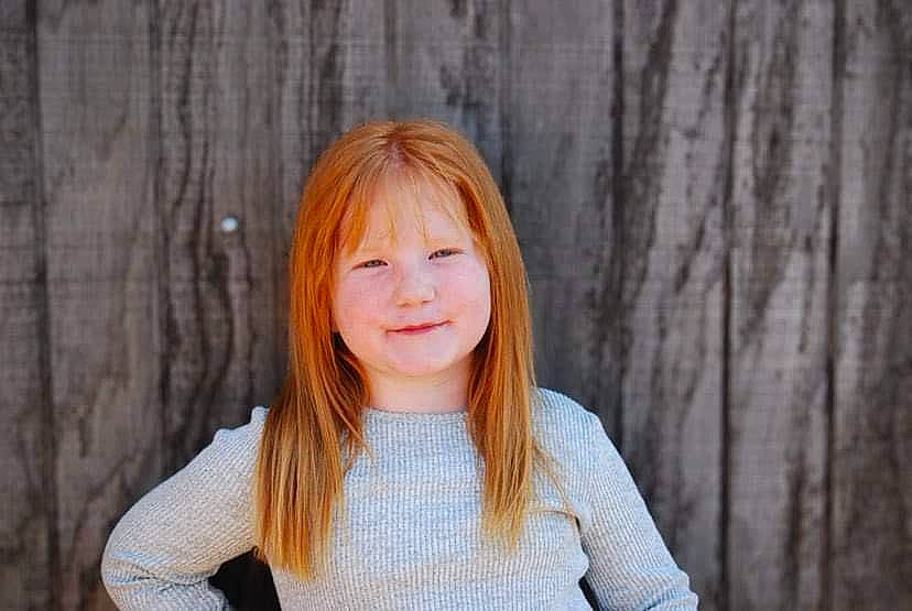 Adalynn is registered to the contest to win money with this photo: bangs, blond, brown_hair, face, flash_photography, gesture, hair, happy, hime_cut, joy, layered_hair, lip, long_hair, peach, people_in_nature, person, sitting, skin, sleeve, smile